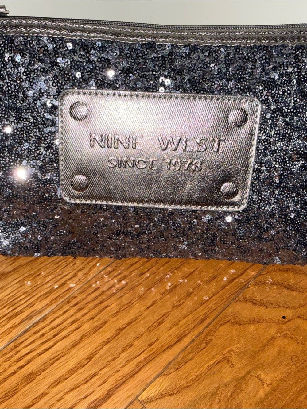 Nine West Black Sequin Wristlet Clutch with Metallic Logo Plate.